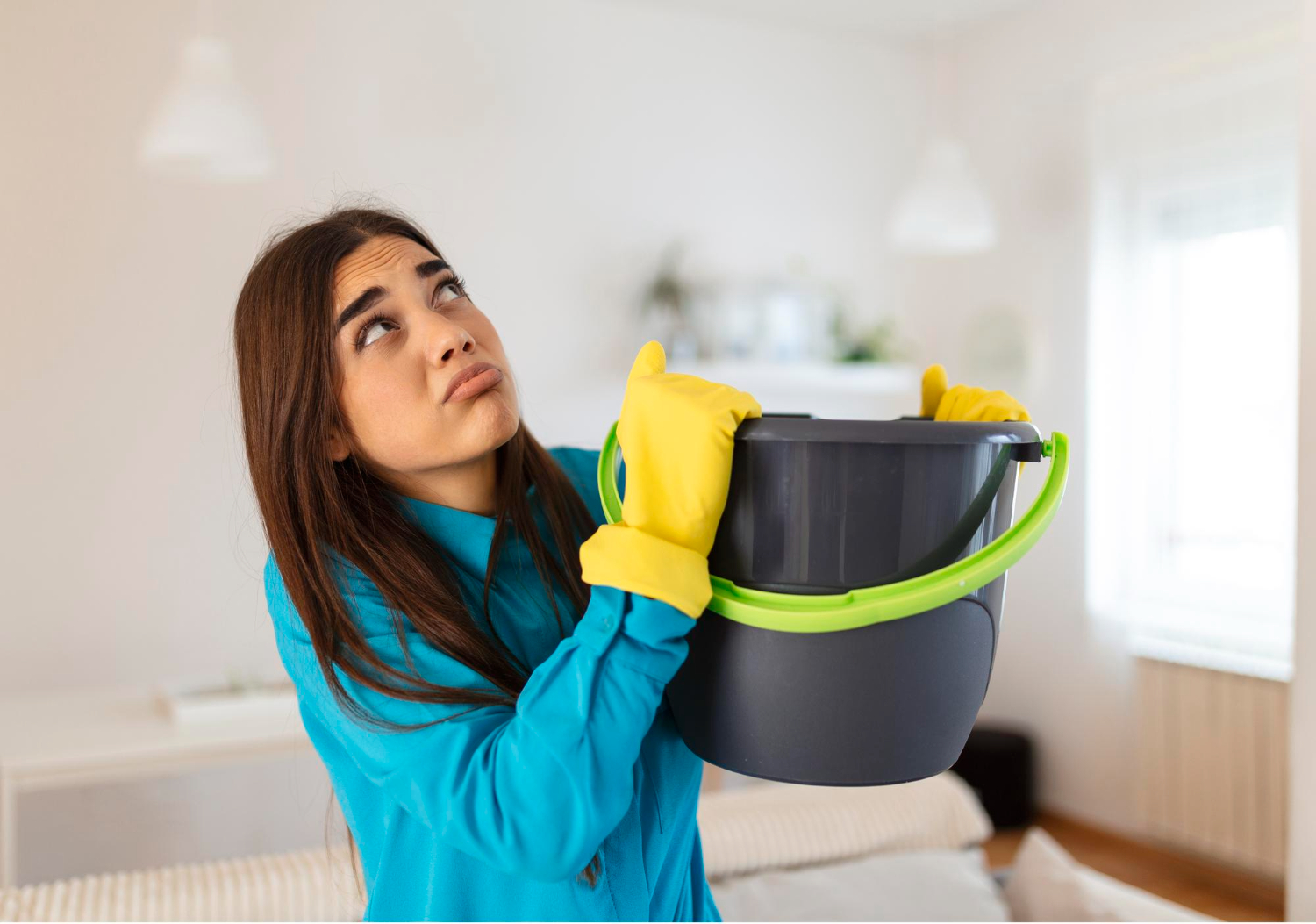shocked-woman-looks-ceiling-while-collecting-water-which-leaks-living-room-home-worried-woman-holding-bucket-while-water-droplets-leak-from-ceiling-living-room (1)
